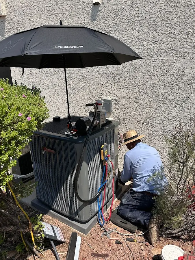 HVAC technician performing outdoor AC maintenance in Tumwater